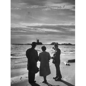  Warren P. Miller and Wife Standing on Beach with Lumberman 