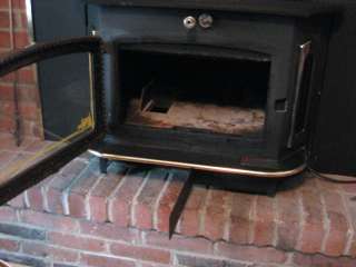 Front view stove with ash trap open and ash tray pulled out.