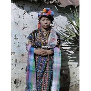  Young Girl Dressed in Traditional Clothing Leans Against a 