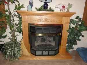Fireplace   Gas log, ventless with oak mantle  